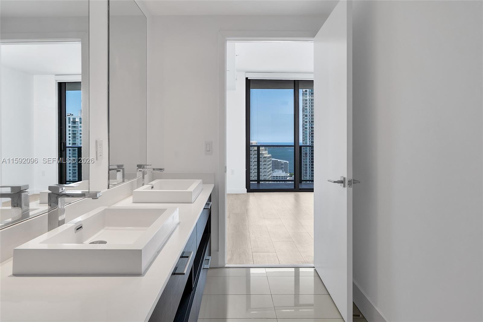 45 Southwest 9th Street, Unit 3502 Miami, FL 33130 - Photo 31 of 46 a bathroom with a sink and a mirror