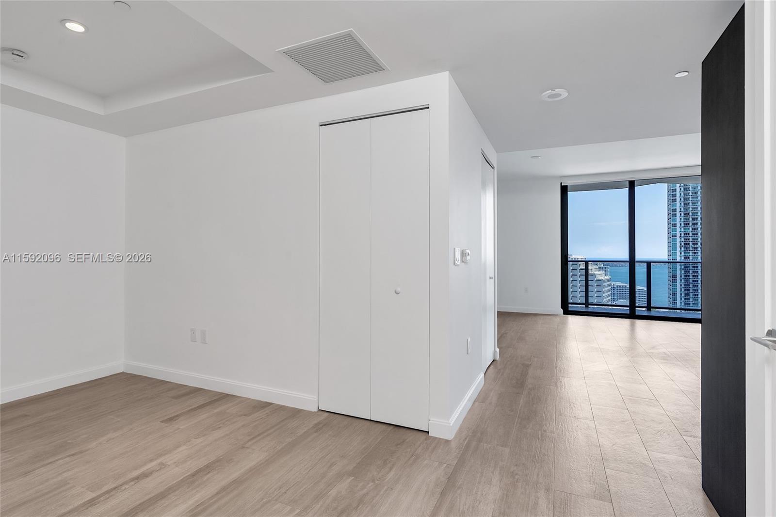 45 Southwest 9th Street, Unit 3502 Miami, FL 33130 - Photo 32 of 46 wooden floor in an empty room with a window