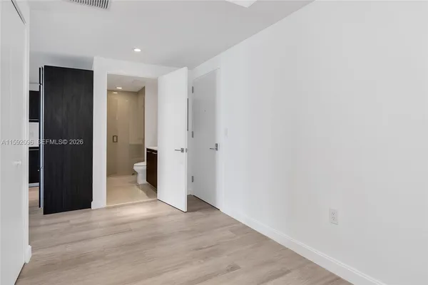 a bathroom with a sink toilet vanity and shower