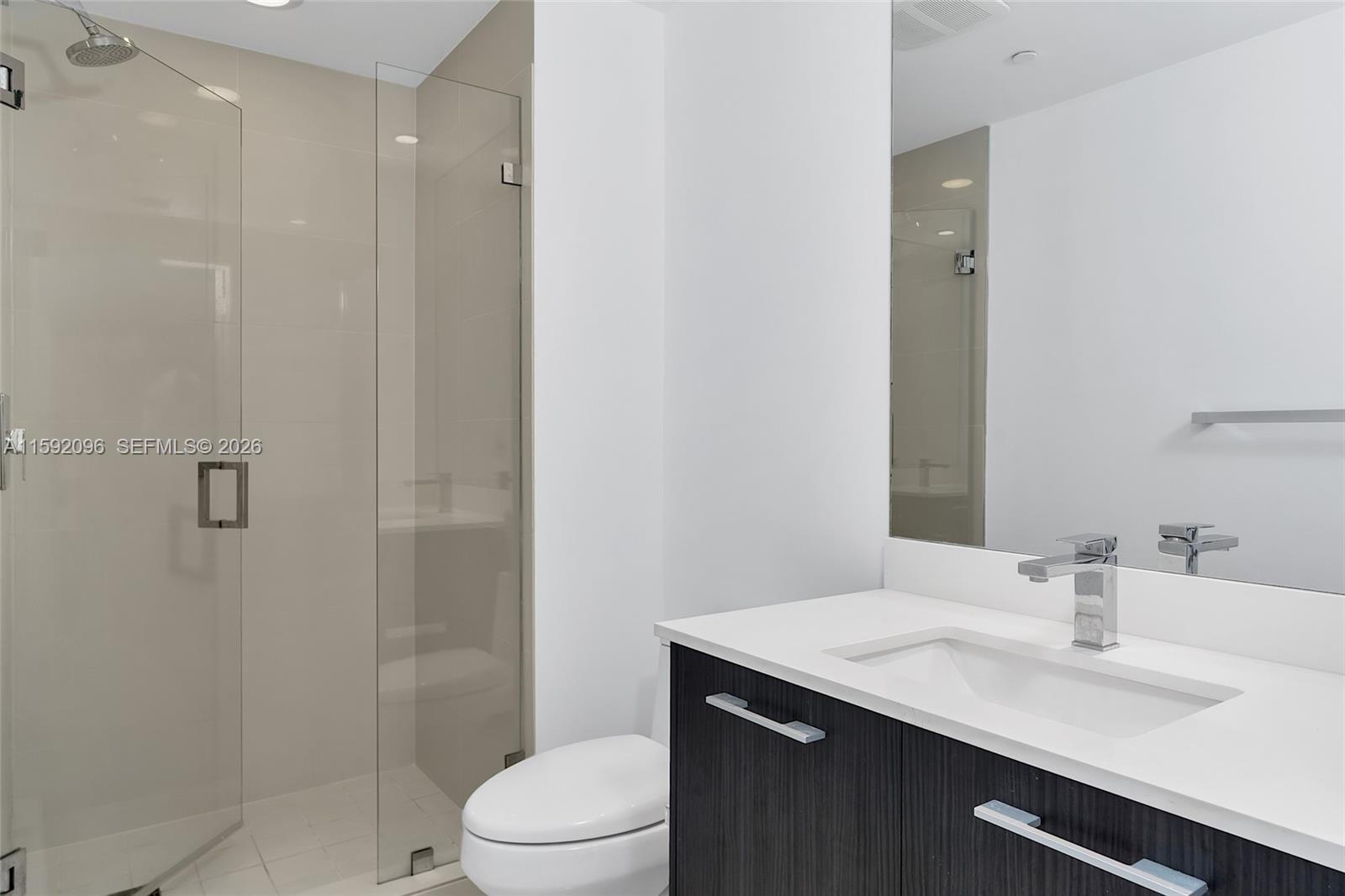 45 Southwest 9th Street, Unit 3502 Miami, FL 33130 - Photo 35 of 46 a bathroom with a sink toilet vanity and shower