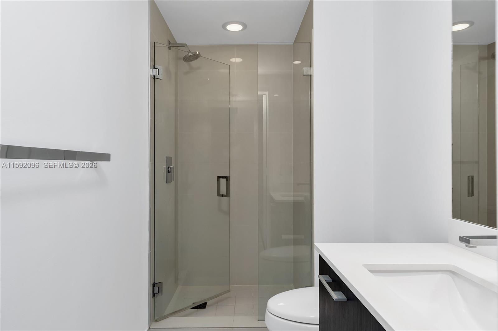 45 Southwest 9th Street, Unit 3502 Miami, FL 33130 - Photo 36 of 46 a bathroom with a sink a toilet and shower