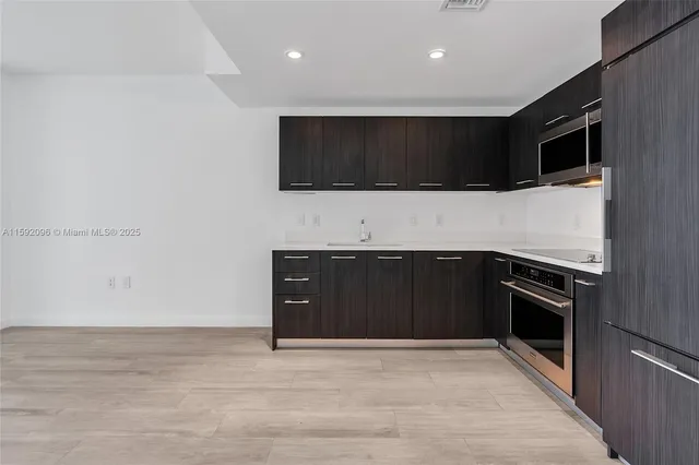 a living room with stainless steel appliances