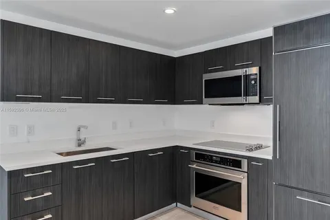 a kitchen with a sink stove and microwave