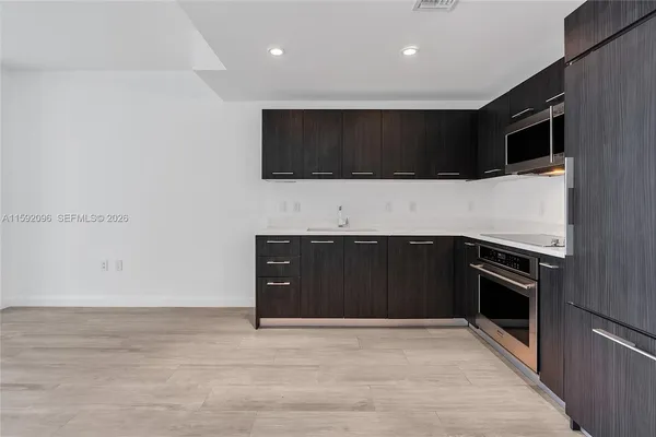 a living room with stainless steel appliances