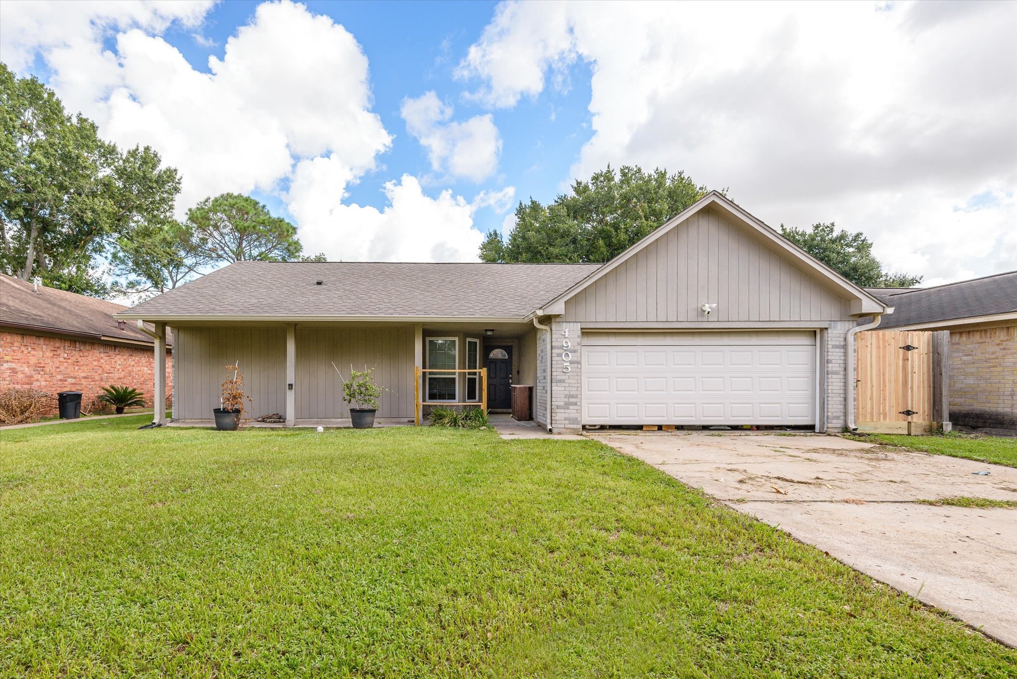 a view of a house with a yard and garage