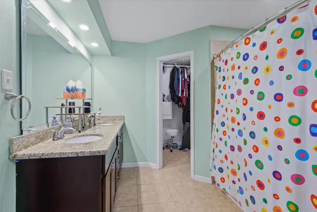 a en suite bathroom with a sink a mirror and a shower