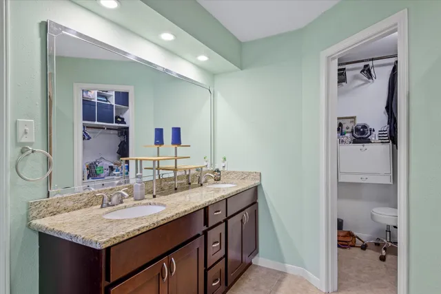 a bathroom with a sink vanity granite and a mirror