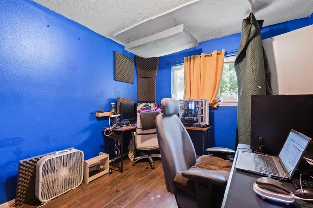 a view of a workspace with furniture and a window