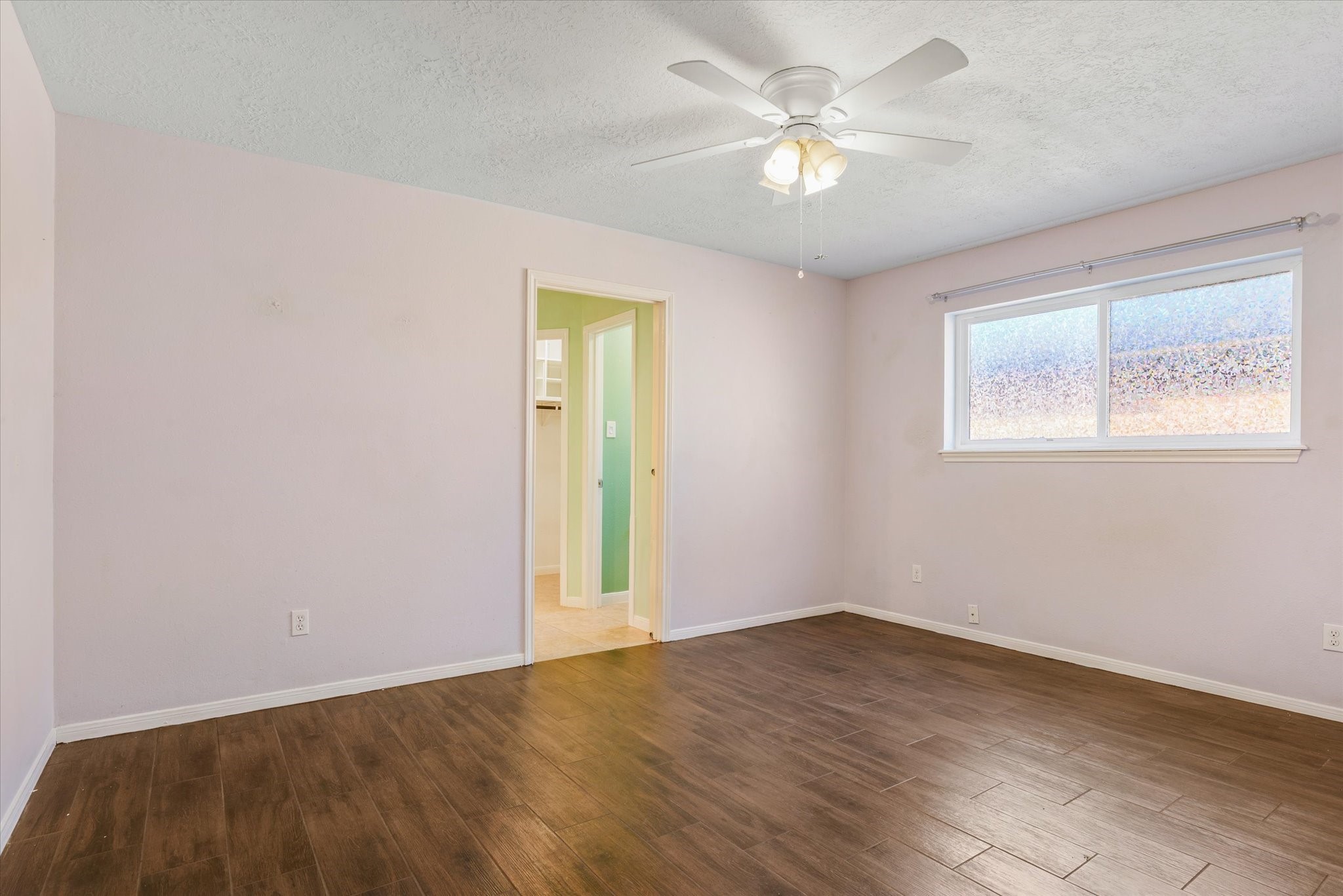 4905 Woodway Avenue Rosenberg, TX 77471 - Photo 15 of 30 an empty room with a chandelier fan and windows