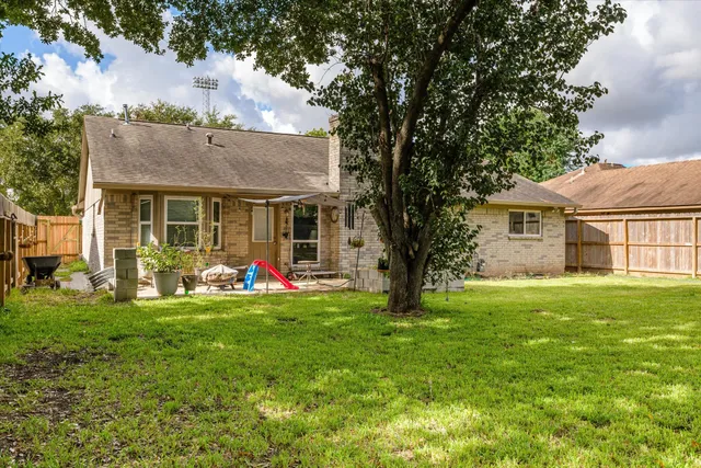 a view of a house with a yard and sitting area