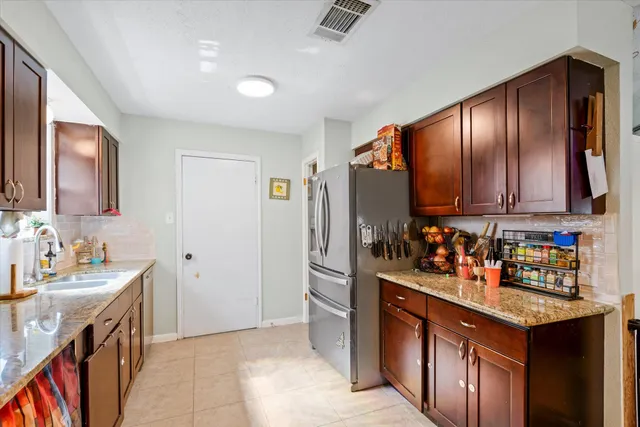 a kitchen with stainless steel appliances a sink stove and refrigerator