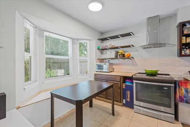 a kitchen with a stove a sink and a refrigerator
