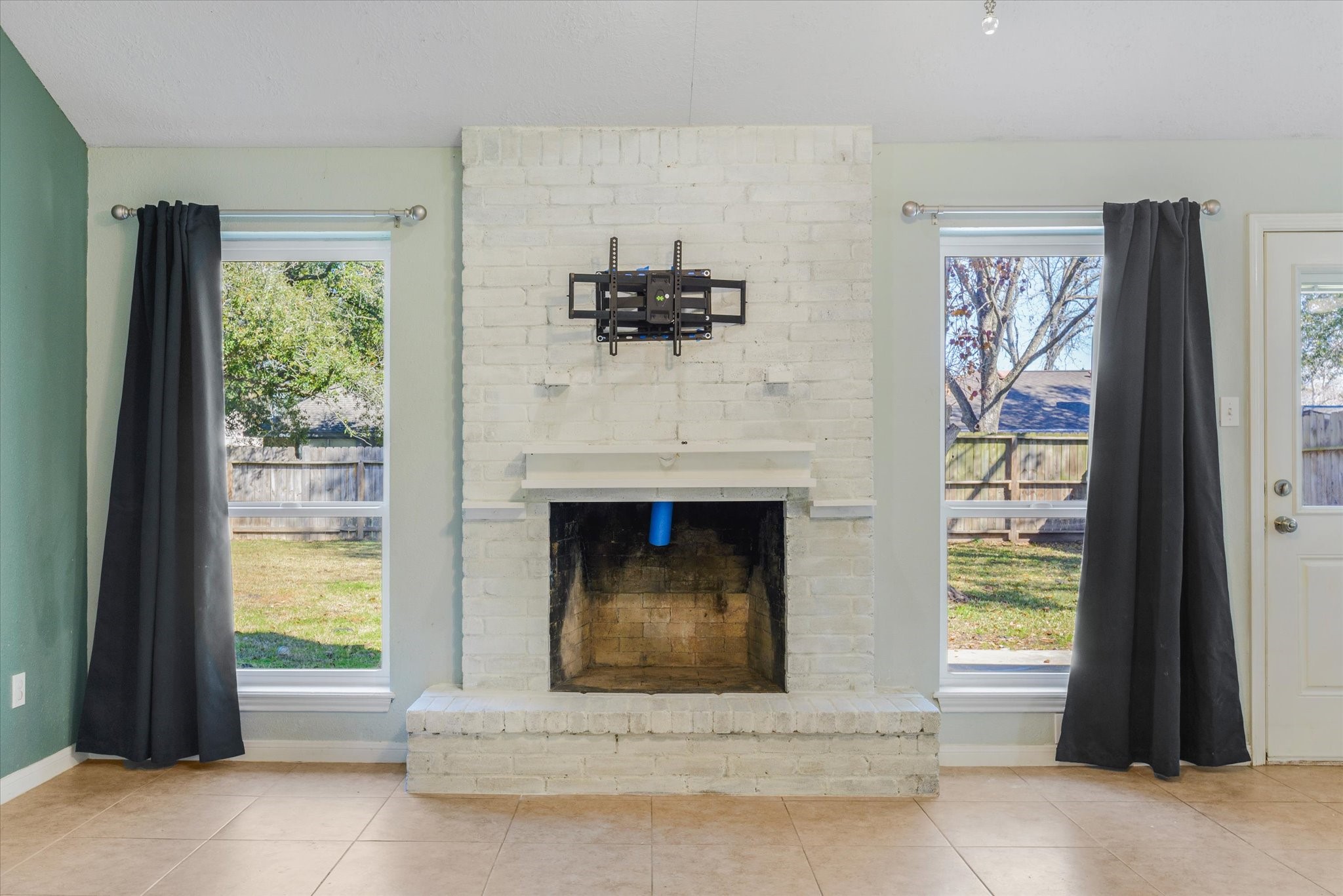 4905 Woodway Avenue Rosenberg, TX 77471 - Photo 9 of 30 a living room with a fireplace and a large window