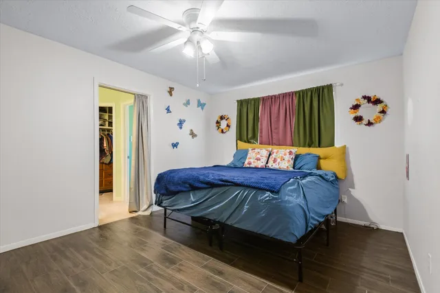 a bed sitting in a bedroom next to a window