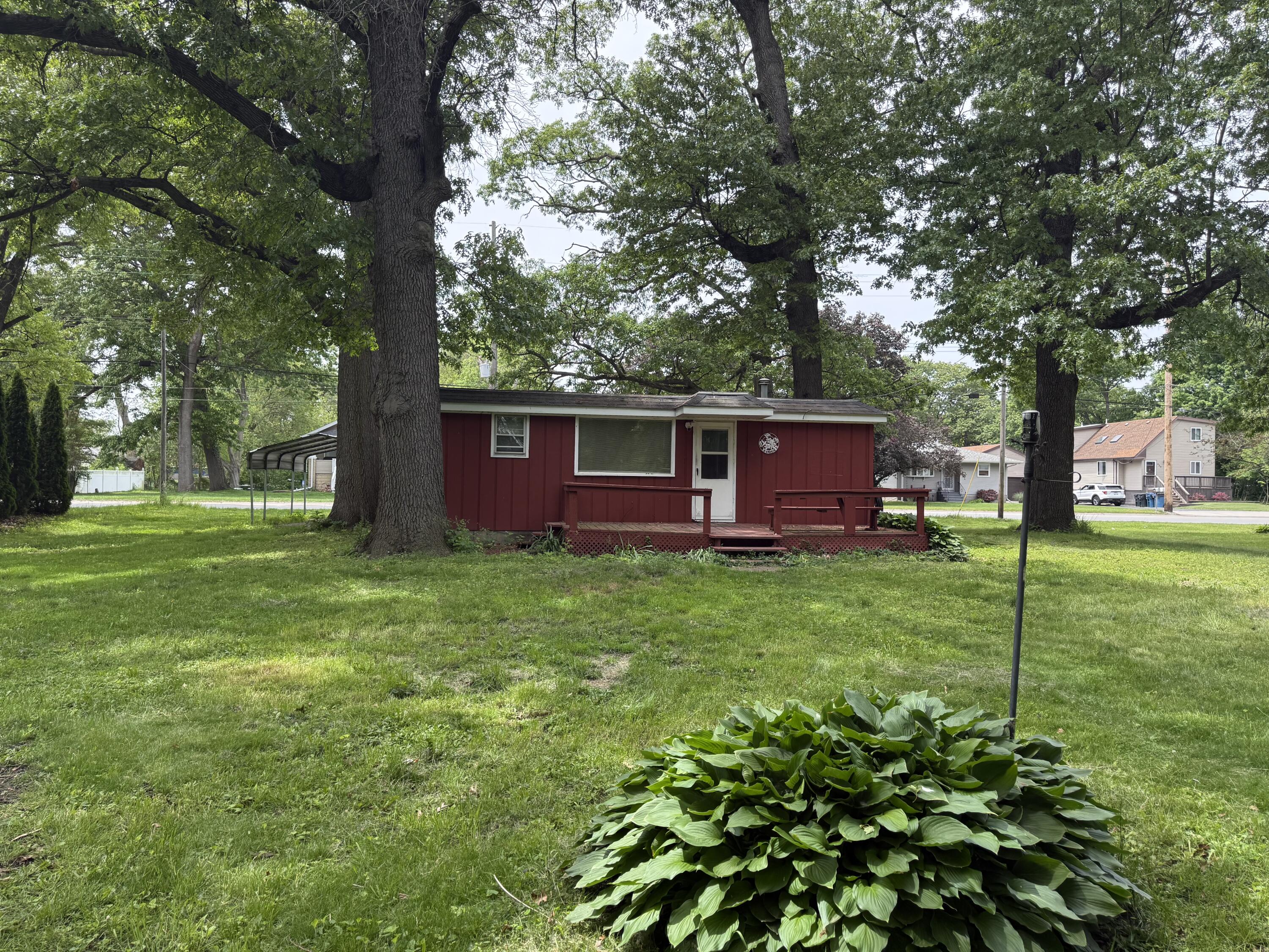 417 North Colfax Street Griffith, IN 46319 - Photo 3 of 5 a view of backyard with large trees and plants