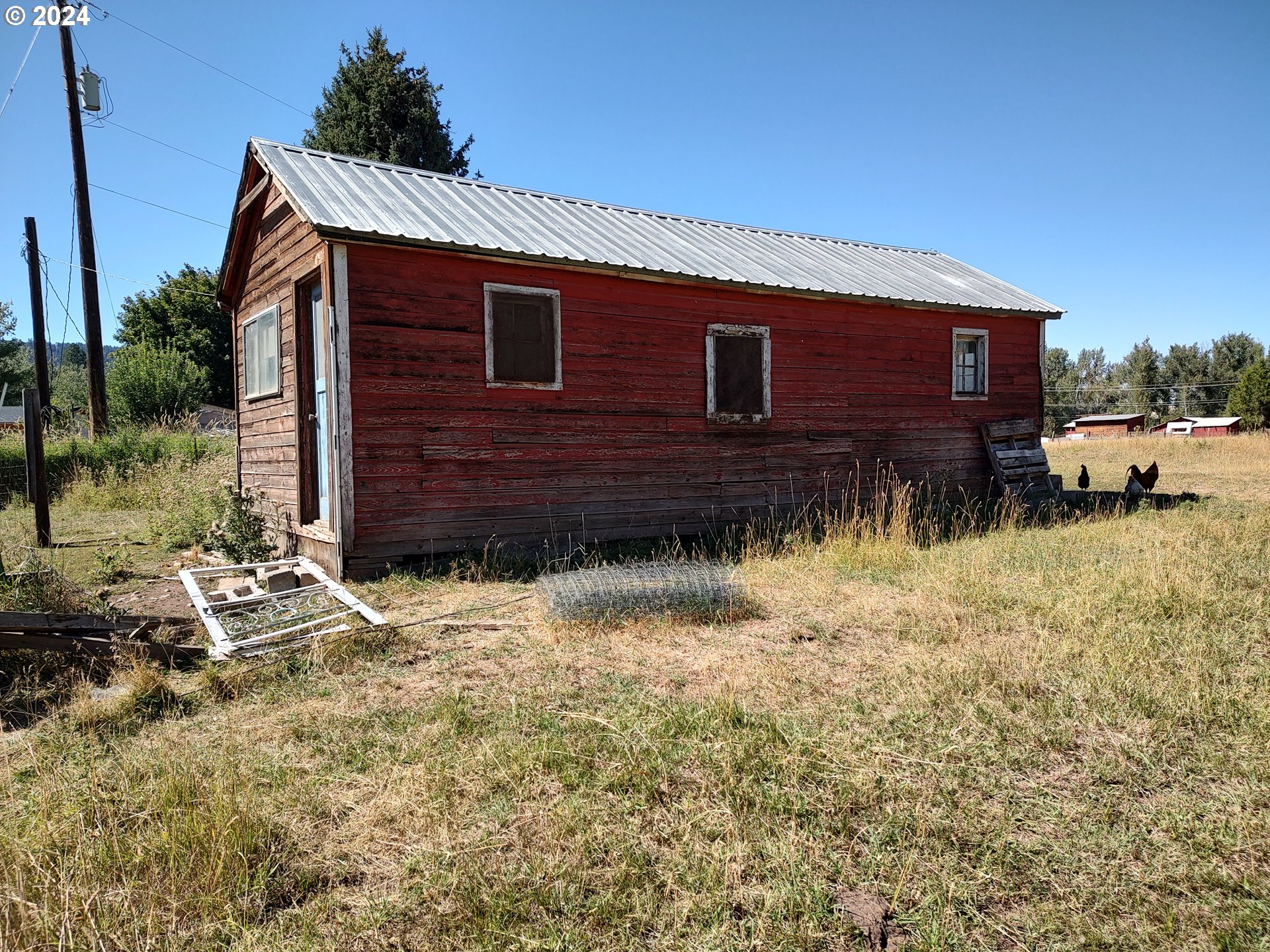 75657 Upper Diamond Lane Wallowa, OR 97885 - Photo 6 of 21 a backyard of a house with wooden fence and a bench