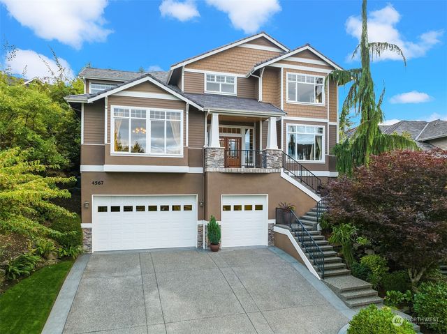 a front view of multi story residential apartment building with yard and retail shops