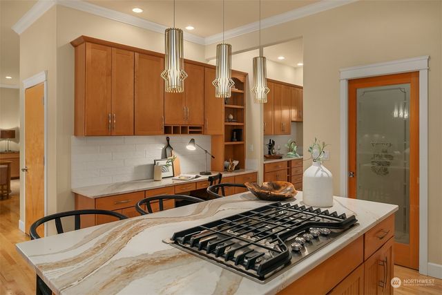 a kitchen with stainless steel appliances a stove a sink and a refrigerator