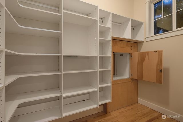 a view of walk in closet with empty racks