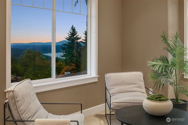 a living room with furniture potted plant and a window