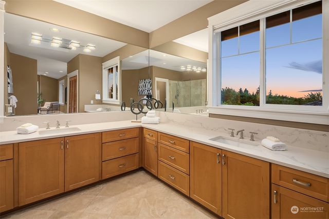 a bathroom with a double vanity sink and a mirror