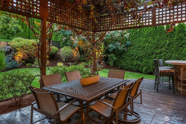 a view of a backyard with table and chairs and couches