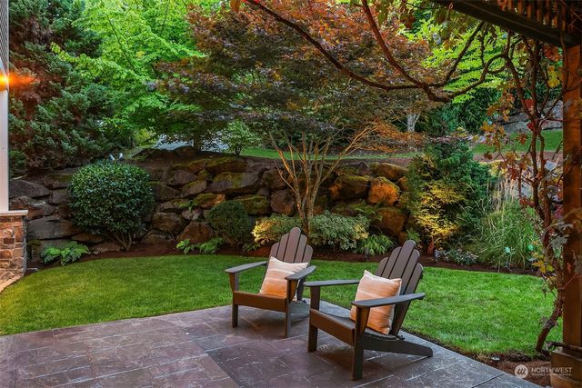 a backyard of a house with table and chairs