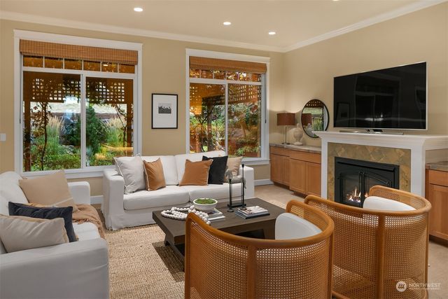 a living room with fireplace furniture and a flat screen tv