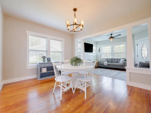 a view of a dining room with furniture window and wooden floor