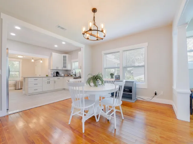a view of a dining room with furniture window and wooden floor