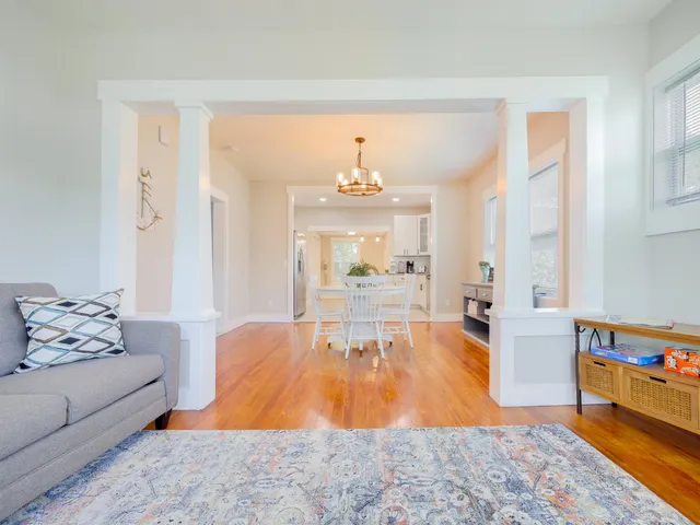a living room with furniture and a dining table