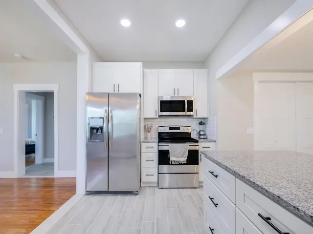 a kitchen with stainless steel appliances a refrigerator and a stove top oven