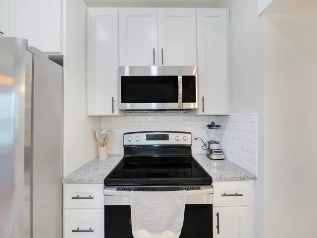 a stove top oven sitting inside of a kitchen