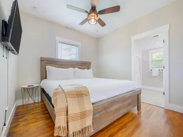 a bedroom with a bed and a flat screen tv