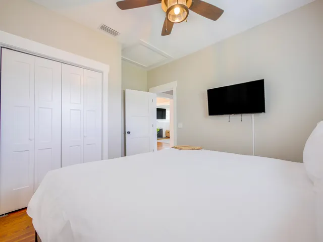 a bedroom with a bed and a flat screen tv