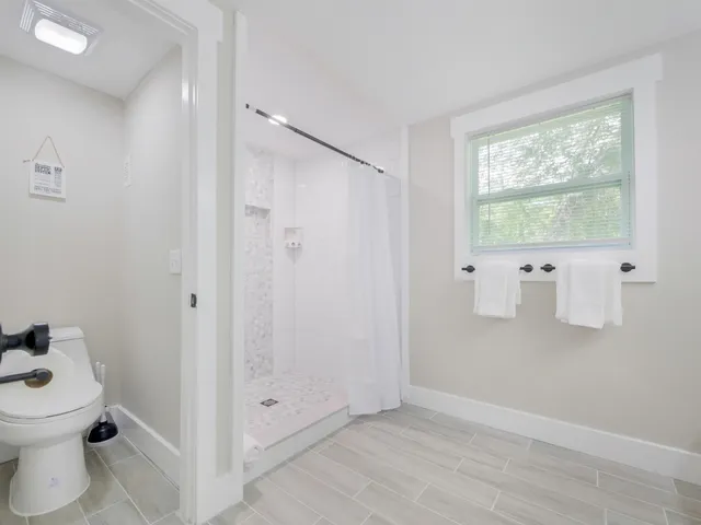 a bathroom with a toilet sink and shower