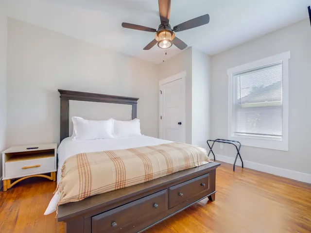 a bedroom with a bed and window