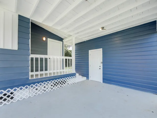 a view of a house with a wooden fence