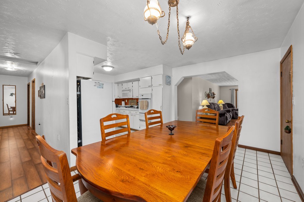 11213 22nd Street Milan, IL 61264 - Photo 23 of 36 a dining room with furniture and wooden floor