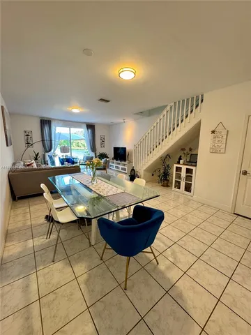 a living room with furniture a table and a potted plant