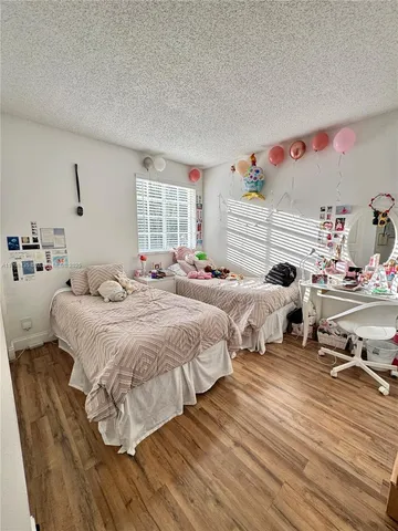 a bedroom with two beds and a window