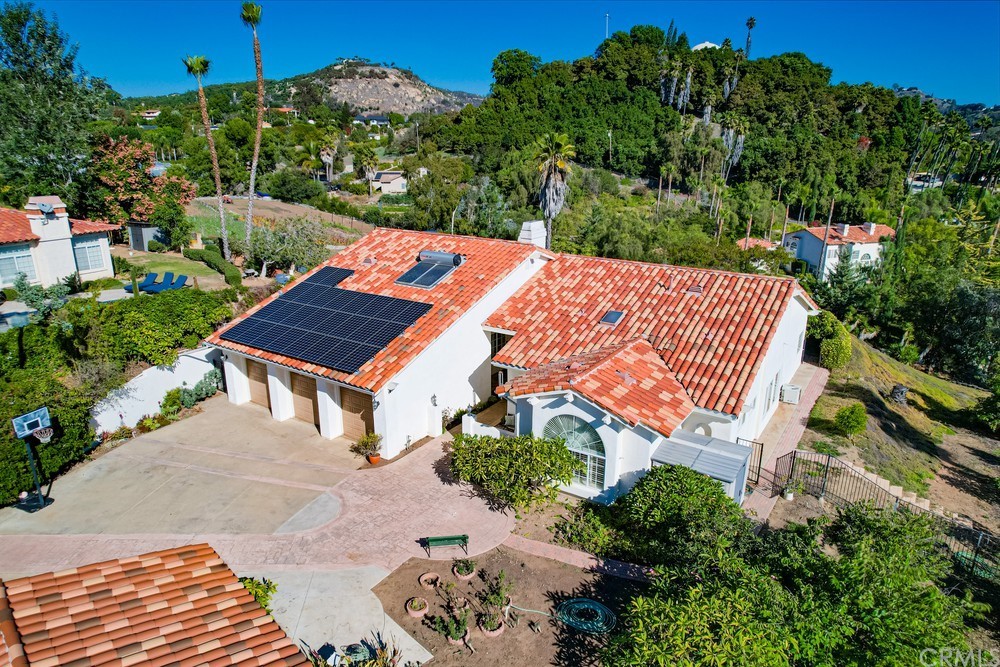 an outdoor sitting area with red umbrella