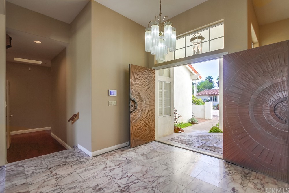 3036 Southwind Lane Vista, CA 92084 - Photo 12 of 45 a view of a hallway with a chandelier glass door and chandelier