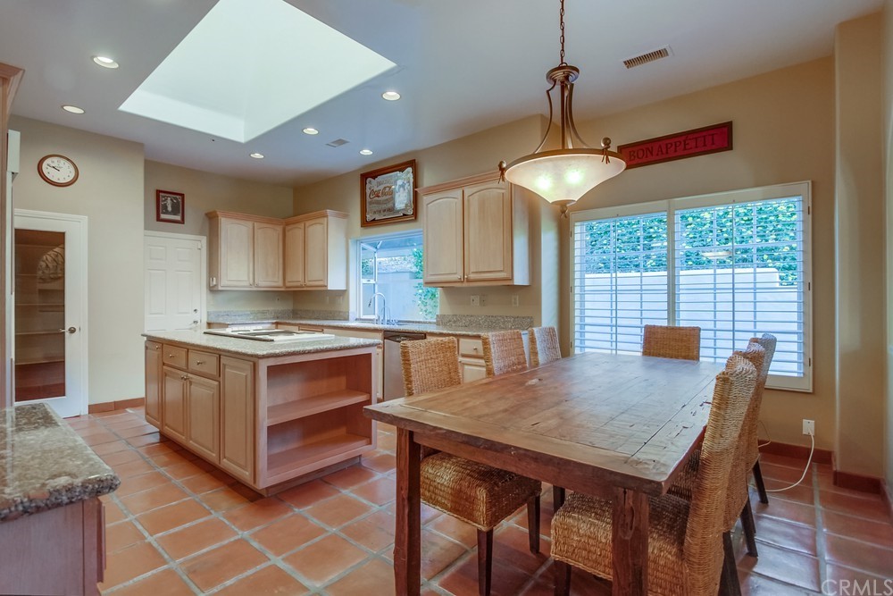 3036 Southwind Lane Vista, CA 92084 - Photo 20 of 45 a kitchen with granite countertop a stove a sink a counter space and wooden floor
