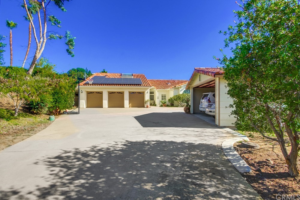 3036 Southwind Lane Vista, CA 92084 - Photo 3 of 45 a front view of a house with a yard and garage