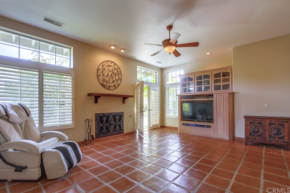 3036 Southwind Lane Vista, CA 92084 - Photo 24 of 45 a living room with furniture a fireplace and a large window