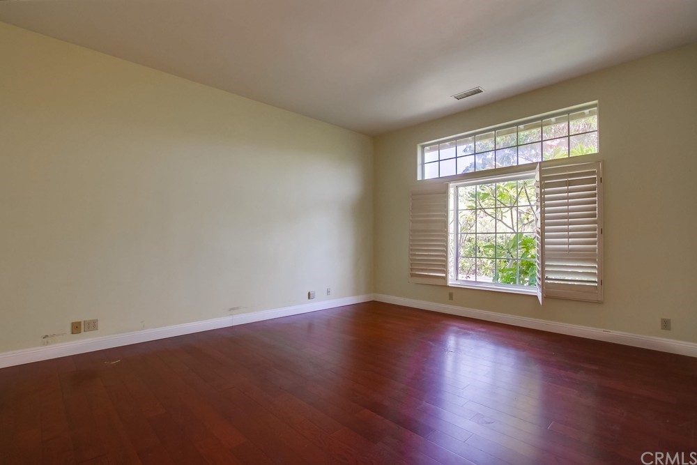 3036 Southwind Lane Vista, CA 92084 - Photo 26 of 45 an empty room with wooden floor and windows