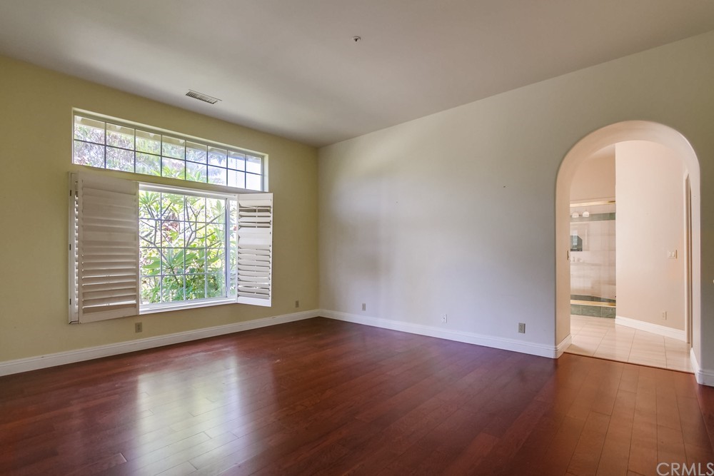 3036 Southwind Lane Vista, CA 92084 - Photo 27 of 45 an empty room with wooden floor and windows