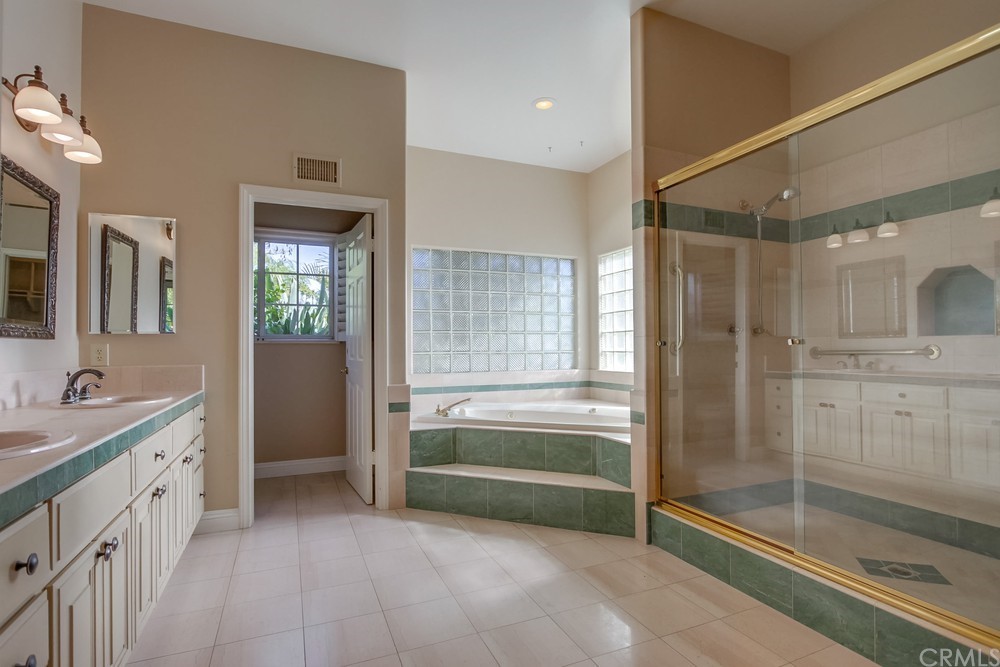 3036 Southwind Lane Vista, CA 92084 - Photo 29 of 45 a bathroom with a tub sink and mirror