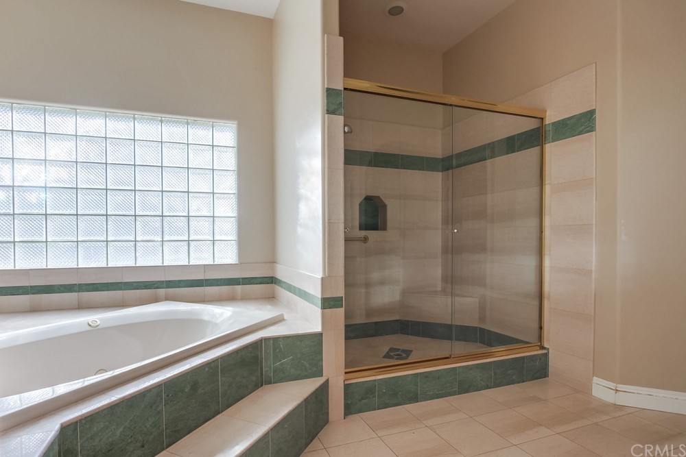 3036 Southwind Lane Vista, CA 92084 - Photo 30 of 45 a bathroom with a bathtub and a shower